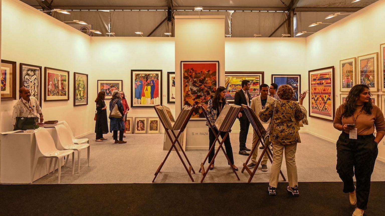 Visitors look at exhibits at the India Art Fair in New Delhi on February 9, 2023