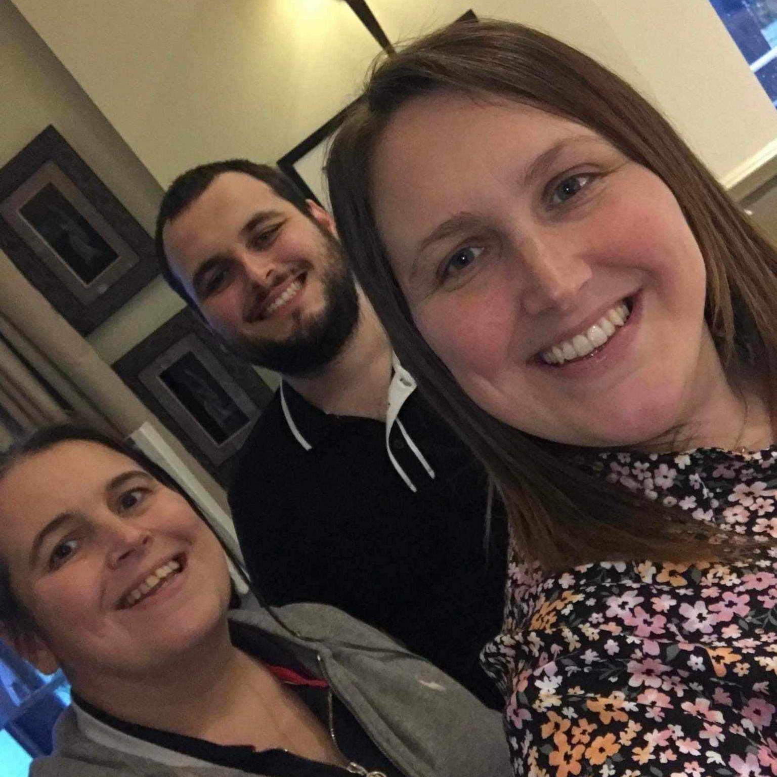 Laura Barlow with her brother and sister. All three are smiling for the camera.