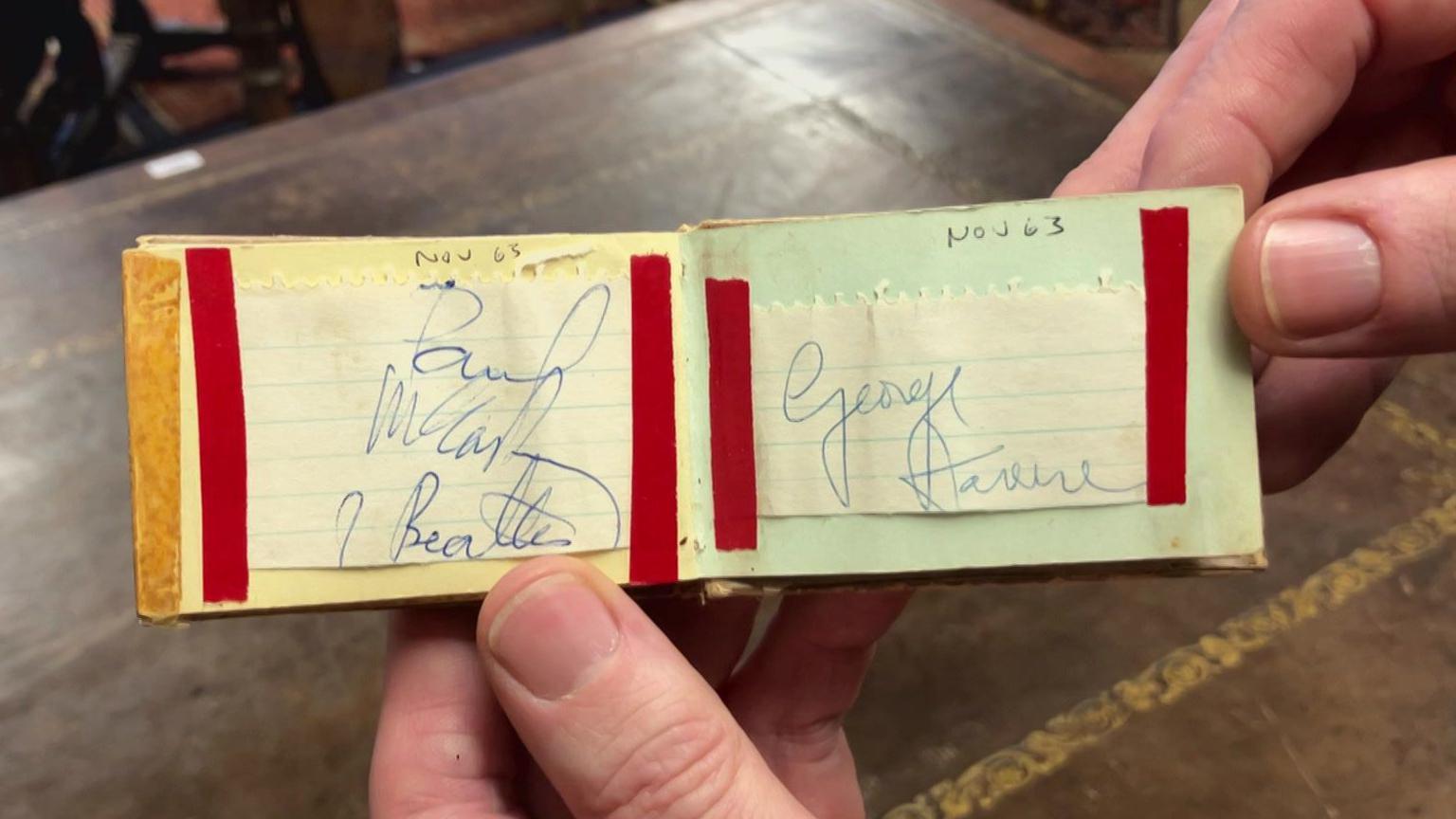 A small book with autographs including that of Paul McCartney and George Harrison. They are dated November 1963.