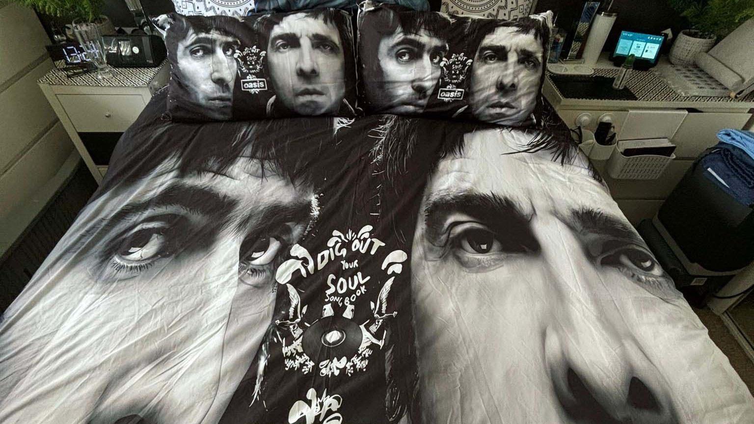 A bed spread with Liam and Noel Gallagher in black and white on the duvet and pillows.