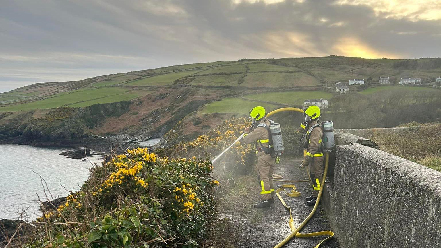 Firefighters with a fire hose