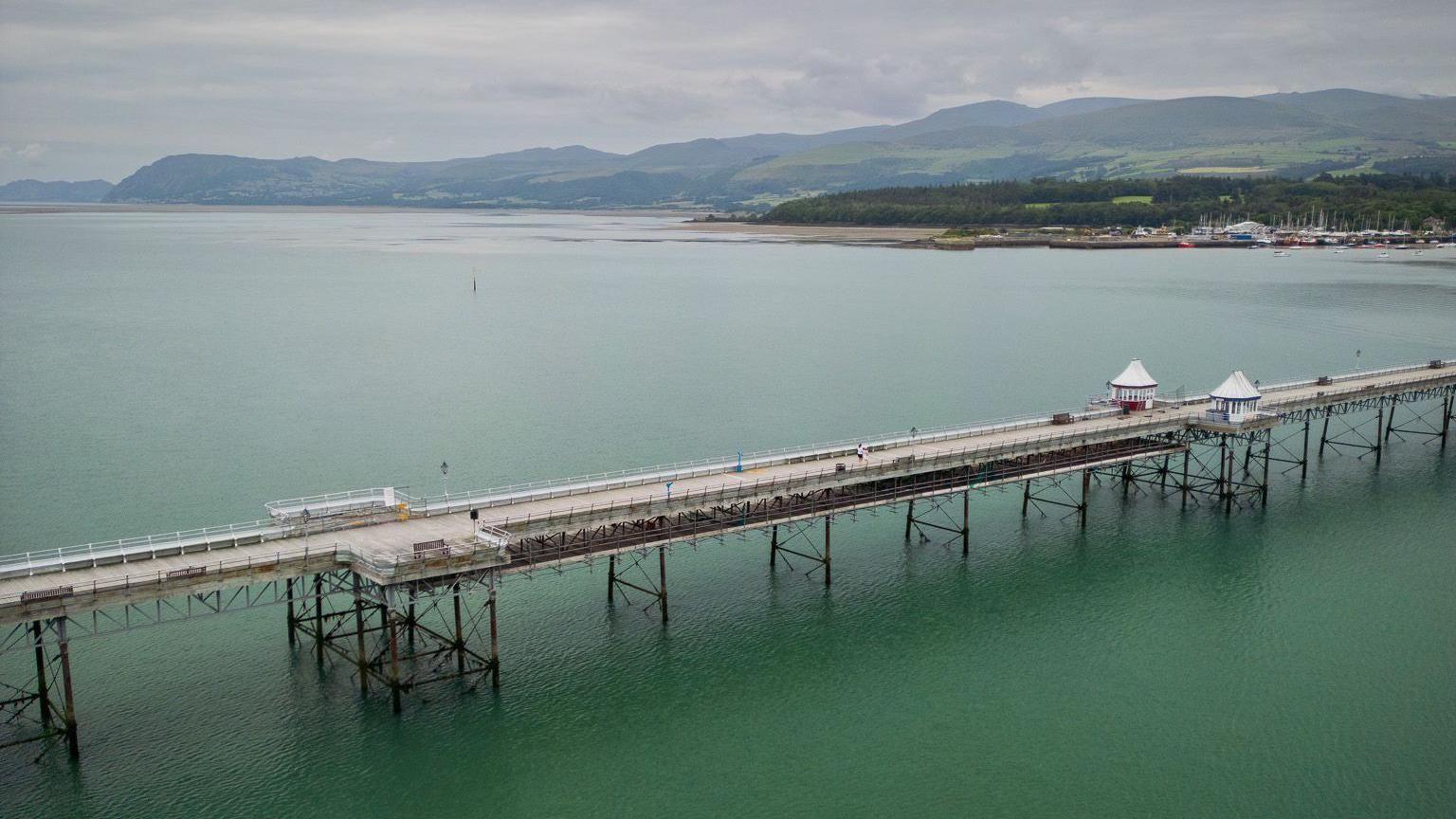 Garth Pier, Bangor from above, with the blue-green sea beneath it
