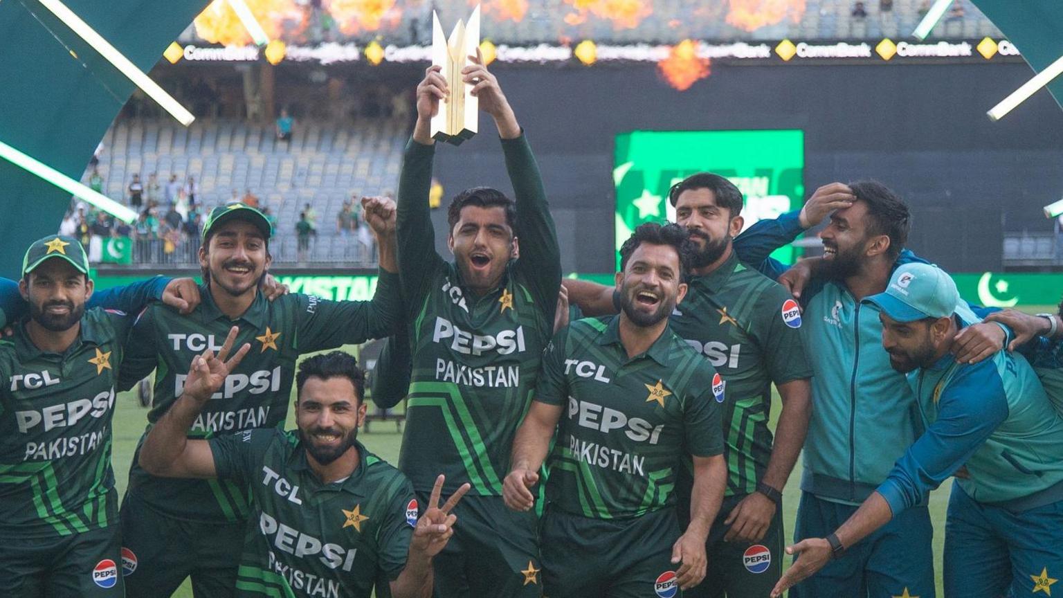 Pakistan players celebrate with the series trophy