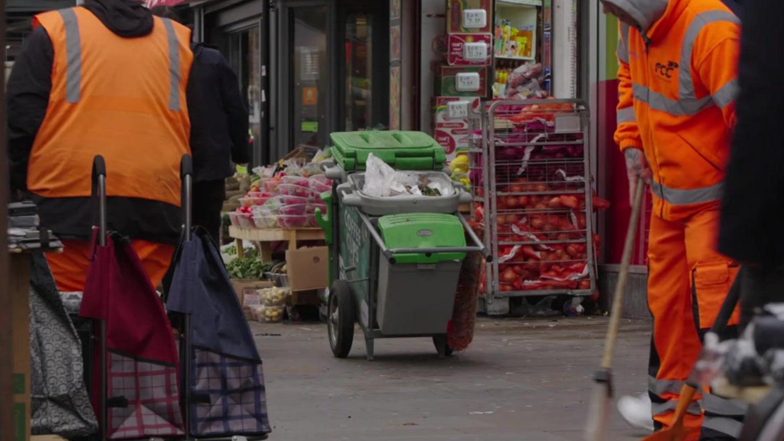 rubbish collectors sweep the streets