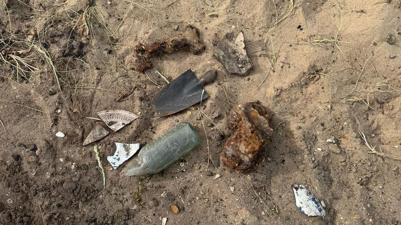 A very small spade and a shells found on the beach 