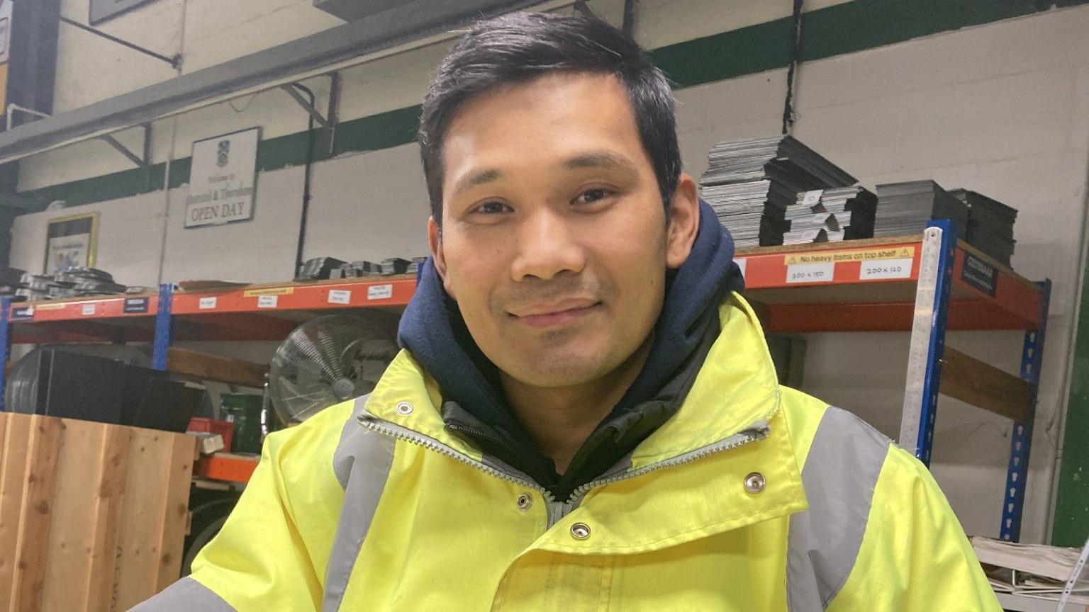 Veteran Tirthraj Thapa, who served with First Royal Gurkha Rifles, Folkestone in Afghanistan, pictured in the RBLI factory. He is wearing a high-viz jacket and navy hoodie. 