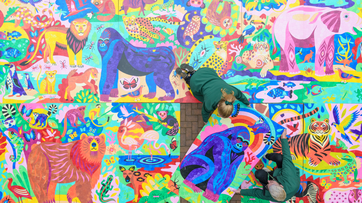 An aerial view of a colourful painting featuring a vast range of animals.