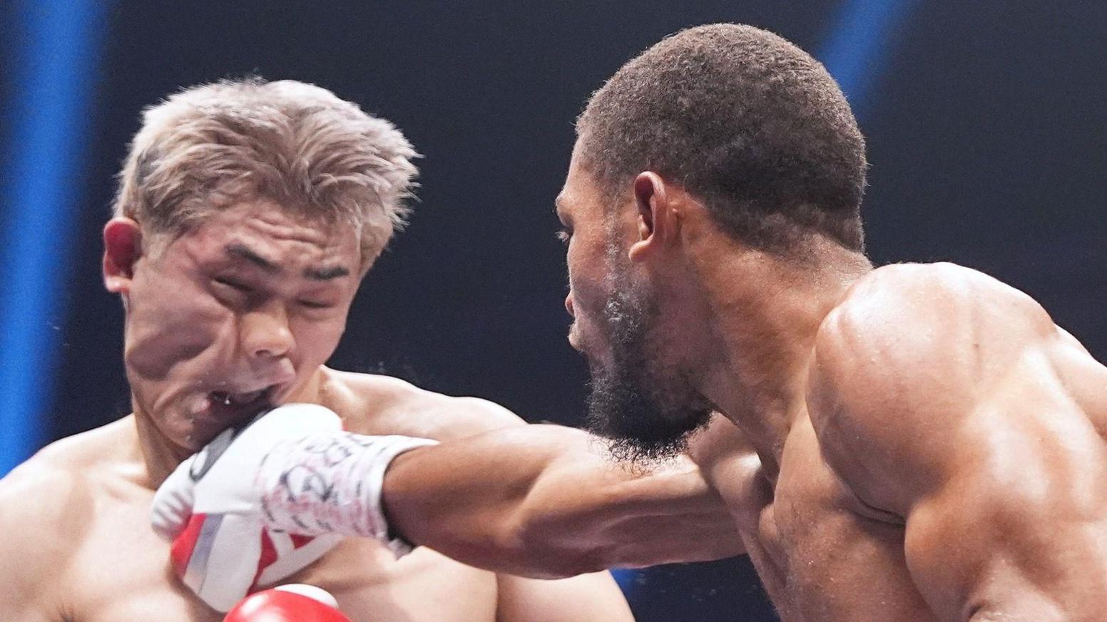 Jin Sasaki's face contorts as he is punched by Brian Norman Jr