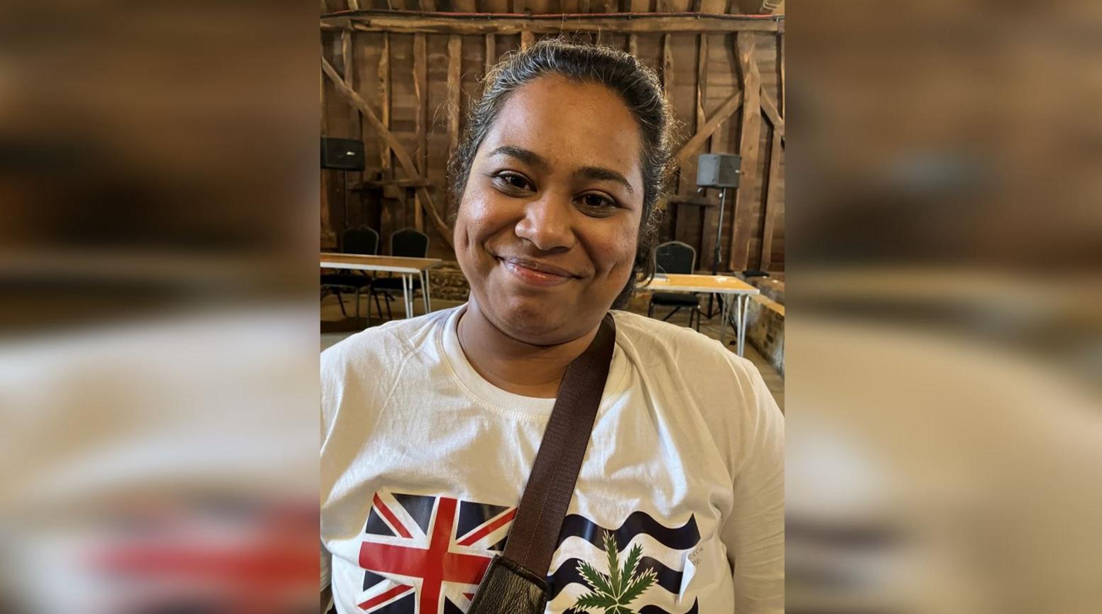 Rebecca Philippe in a white T-shirt featuring the British Indian Ocean Territory Flag.