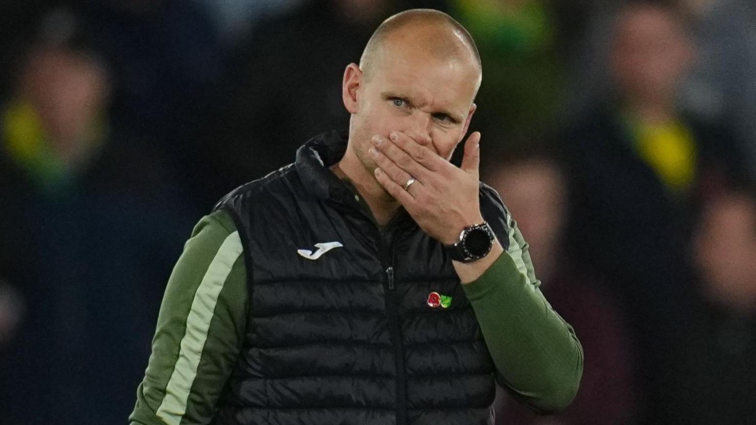 A pensive looking former Norwich boss Liam Manning