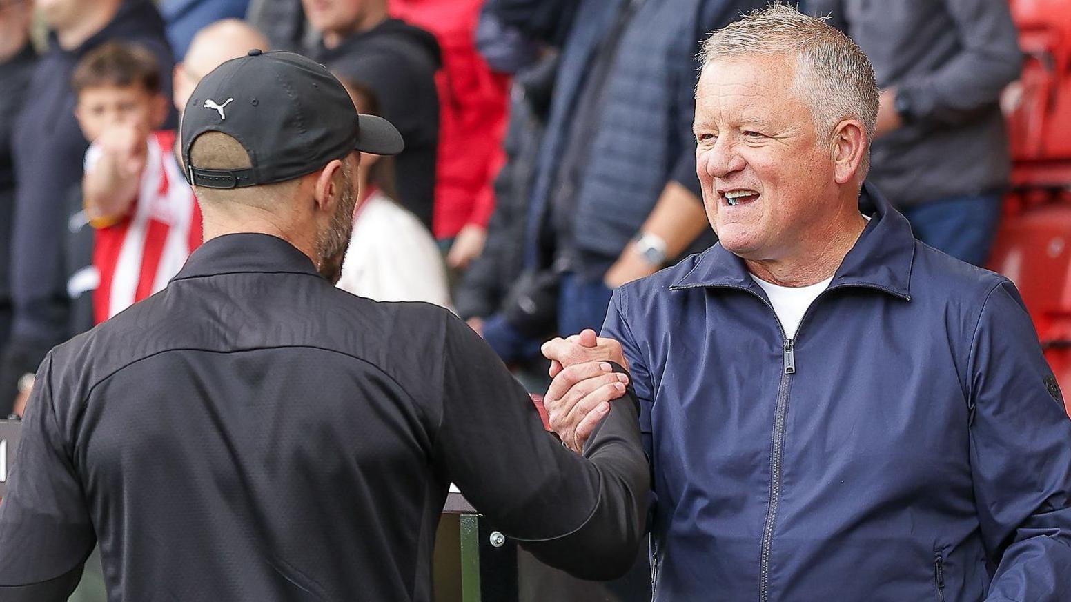 Chris Wilder clasps hands with Paul Warne