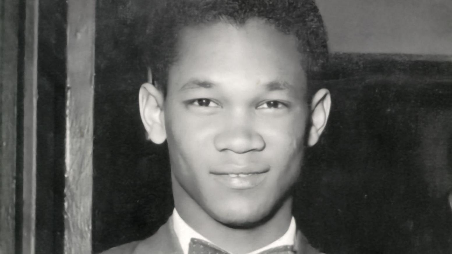 A close-up black and white photograph of Harold Phillips as a young man. He is wearing a suit and a bow tie.