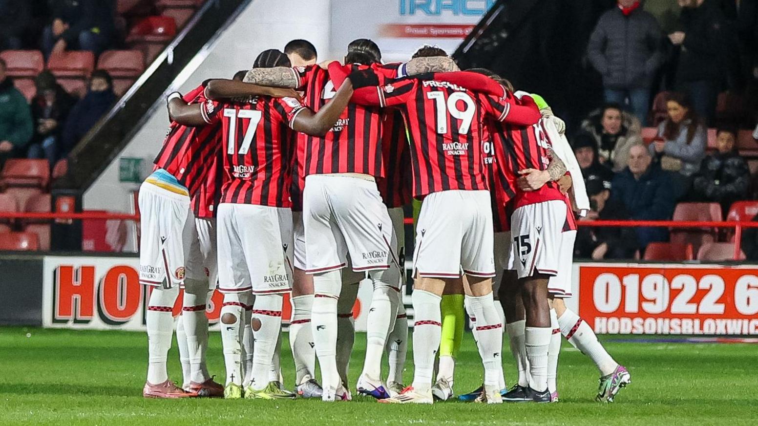 Walsall players in a huddle before kick-off
