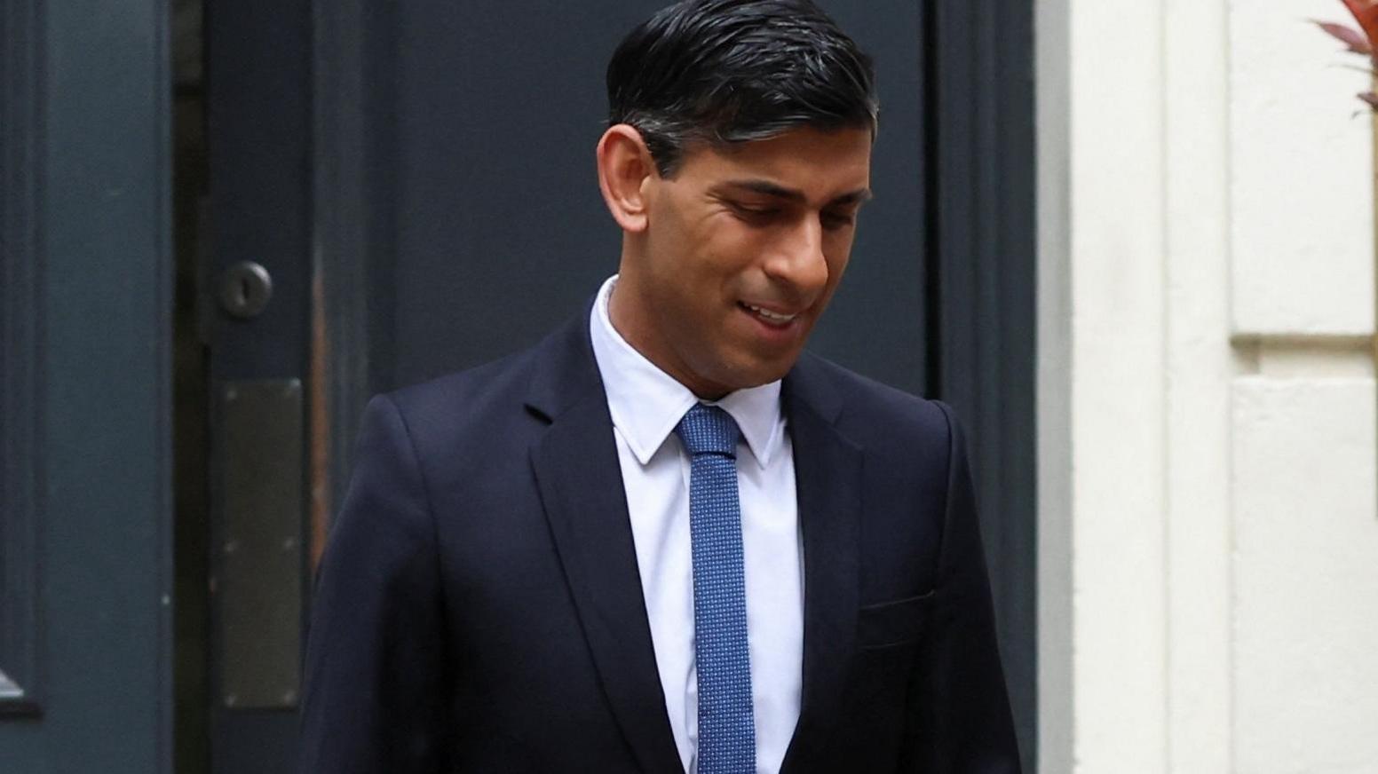 Rishi Sunak, head slightly bowed, leaving campaign HQ on Friday 5 May