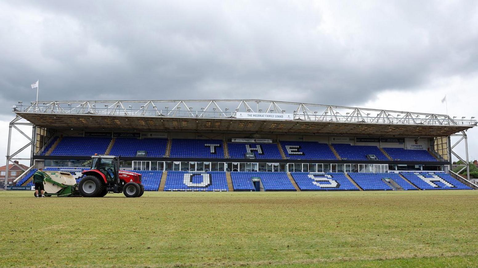 A red tractor on the pitch at Weston Homes Stadium