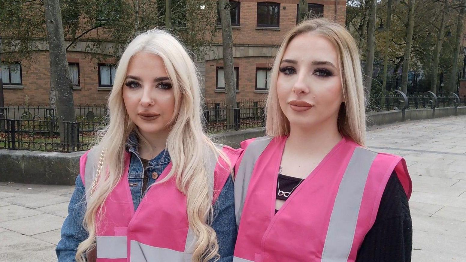 Bobbi-Leigh and Shannon McIlwaine wearing fluorescent pink jackets.