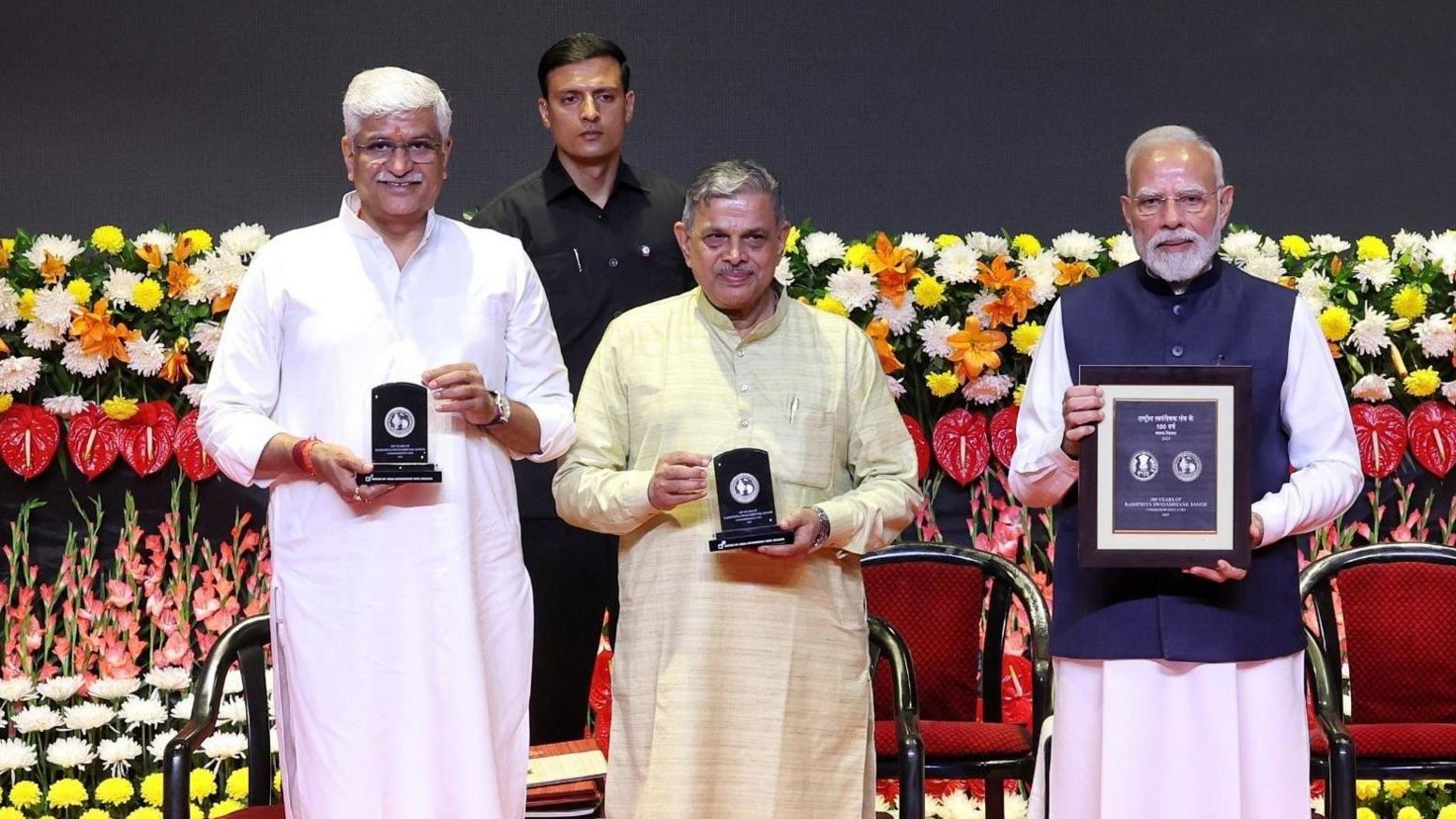 Indian Prime Minister Narendra Modi releases a commemorative stamp and coins during an RSS event in Delhi 