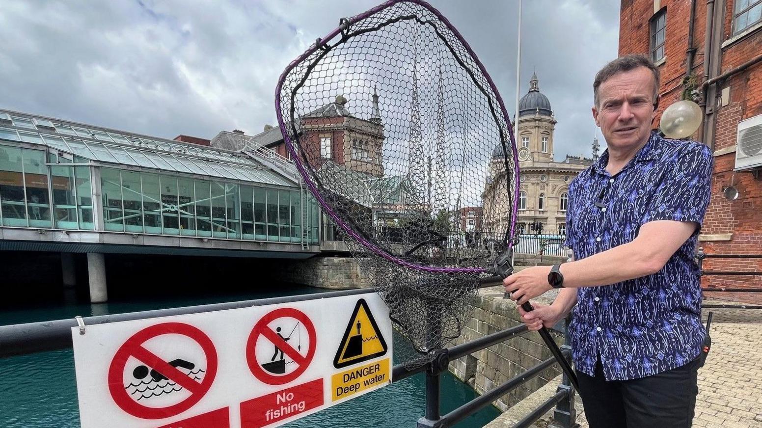 Mark Bayston with a landing net at Princes Quay in Hull