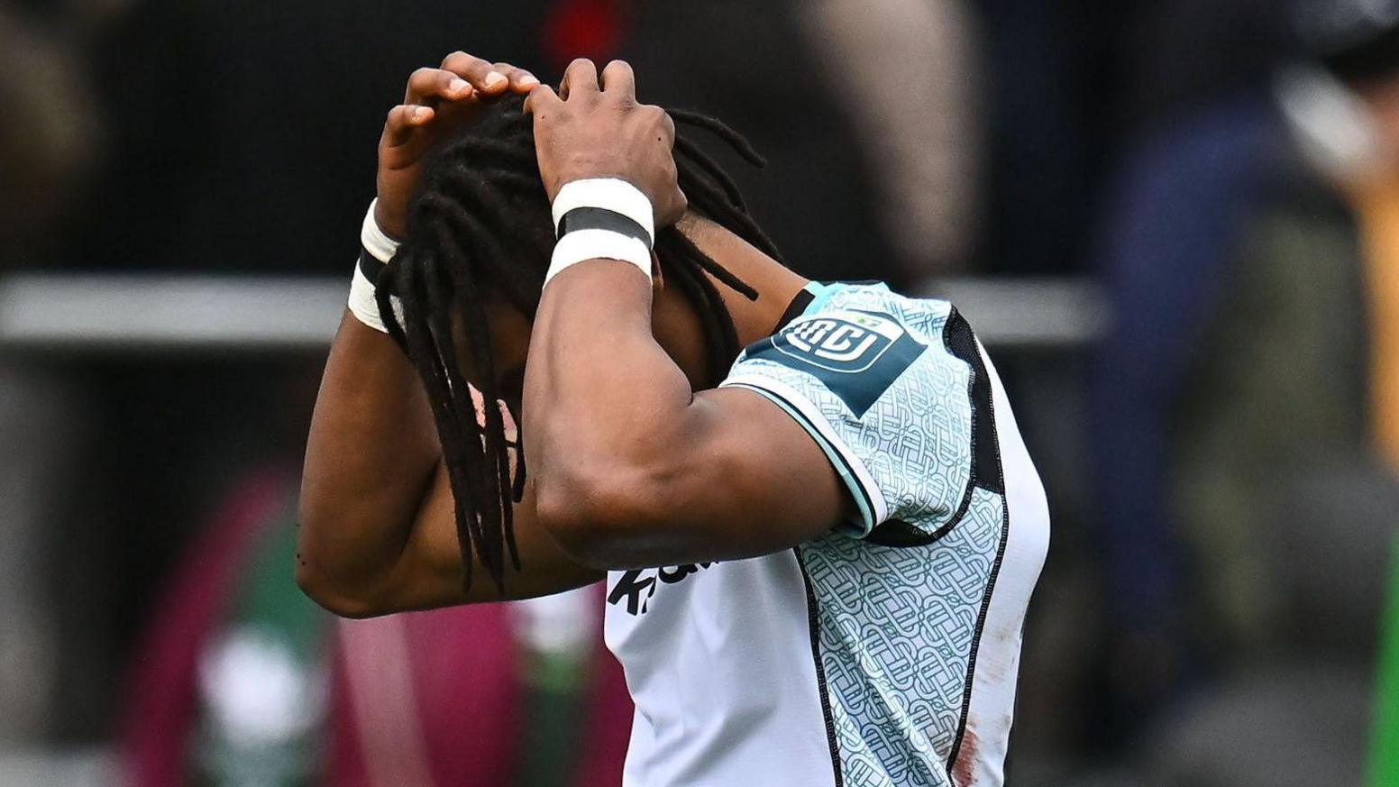 Ospreys wing Daniel Kasende holds his head