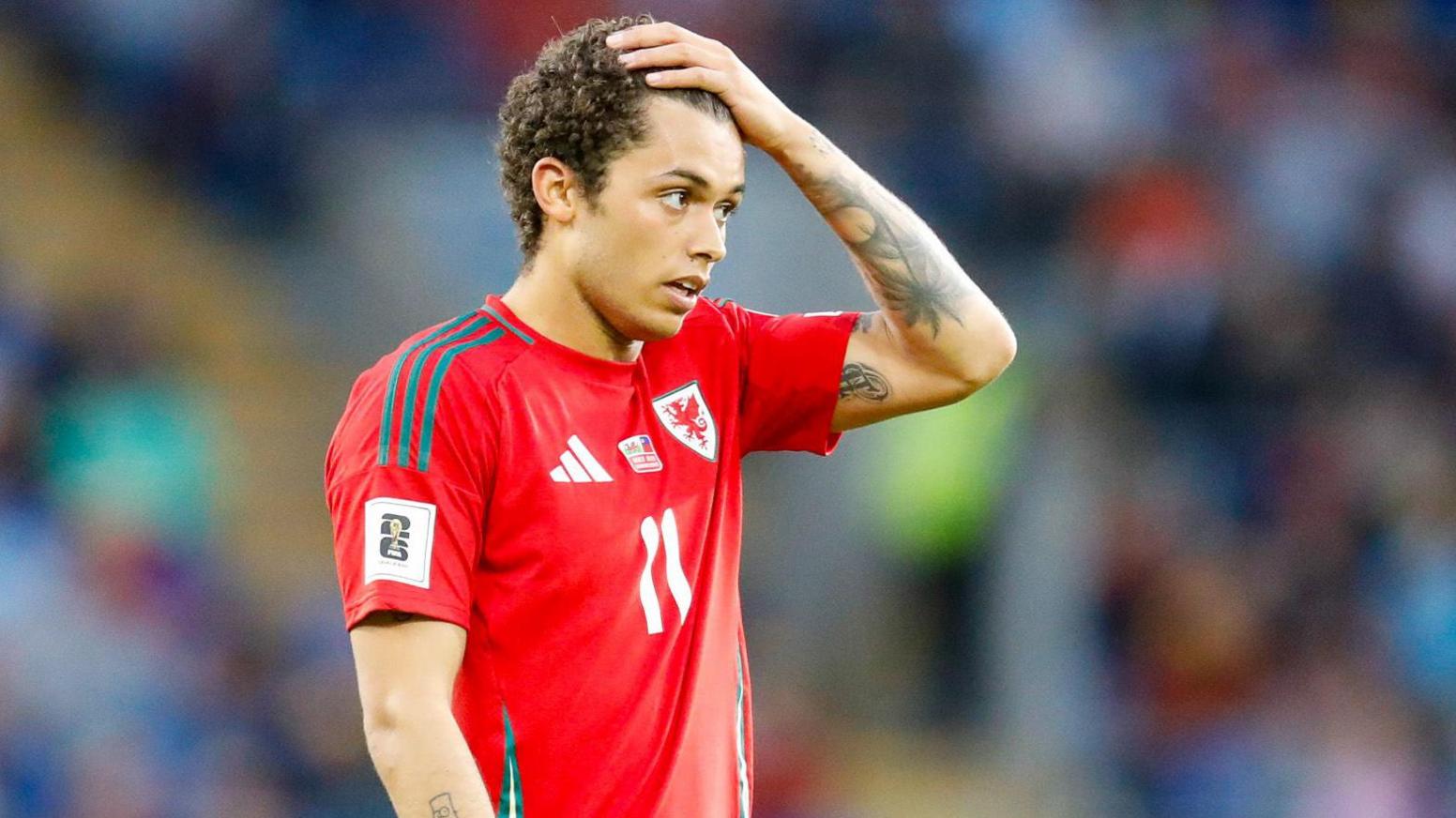 Brennan Johnson puts his hand on his head in disappointment