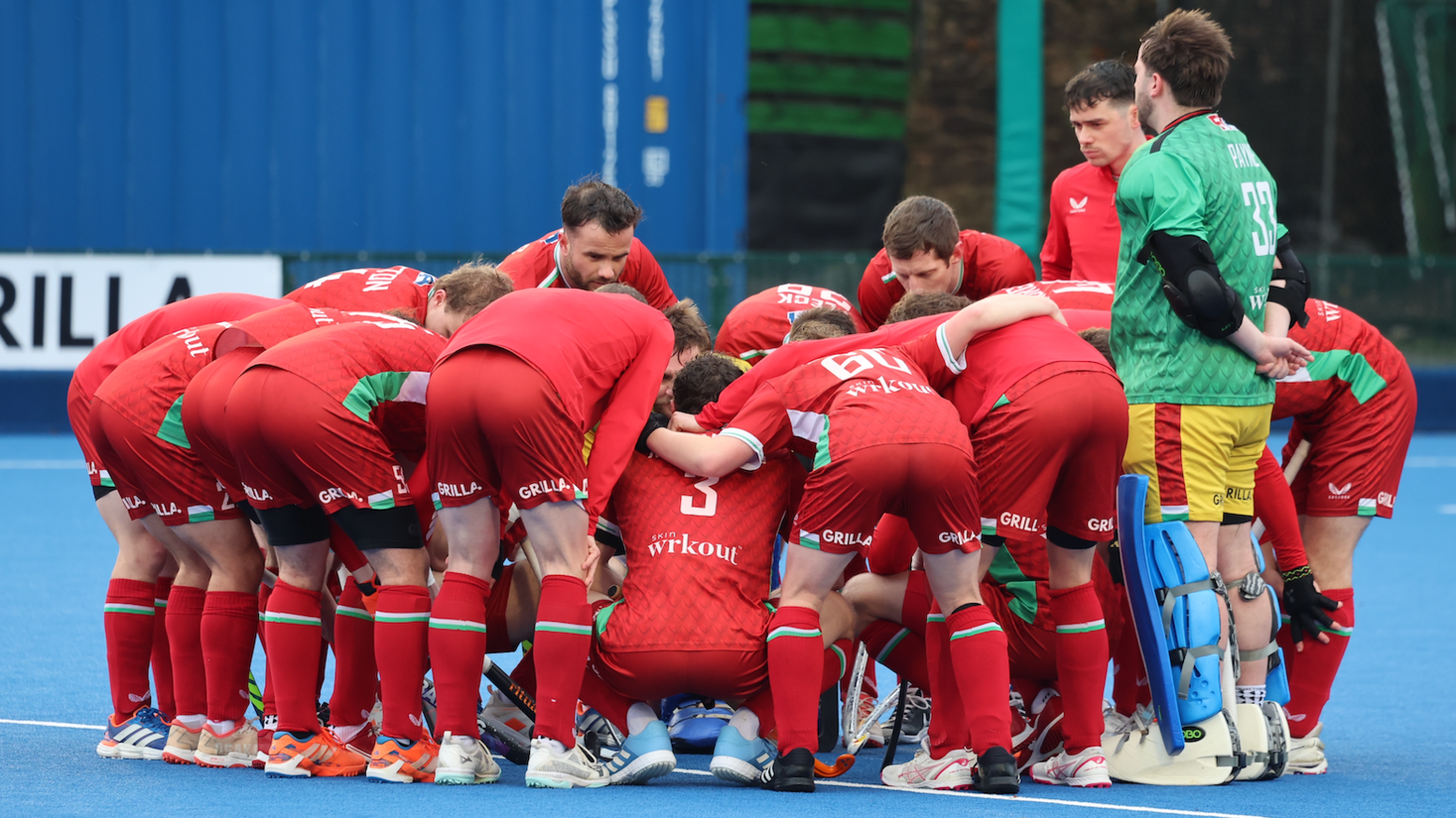 Wales men hockey squad in a huddle