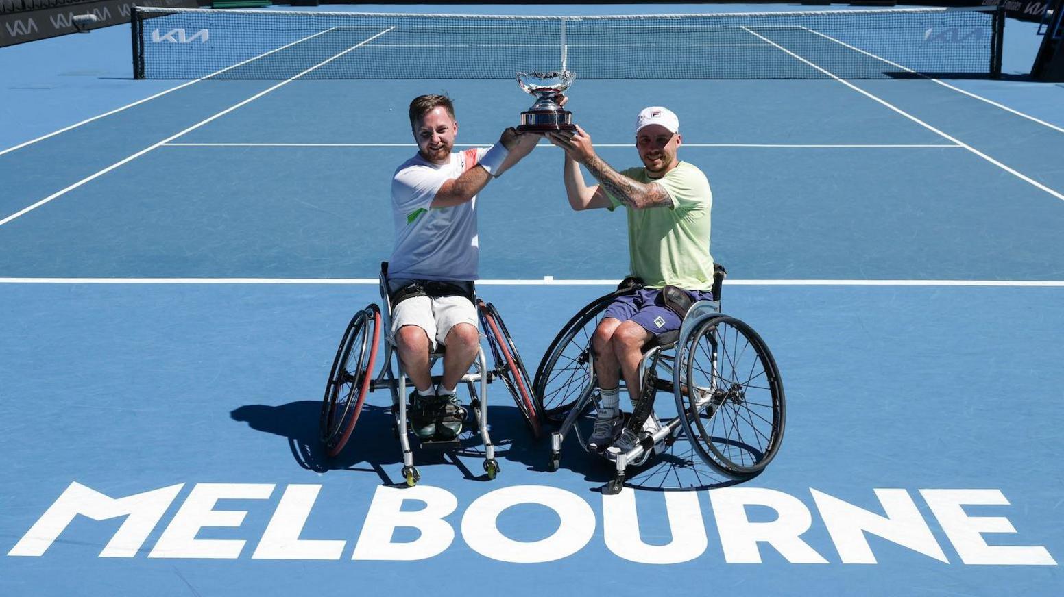 Sam Schroder and Andy Lapthorne hold their Australian Open trophy