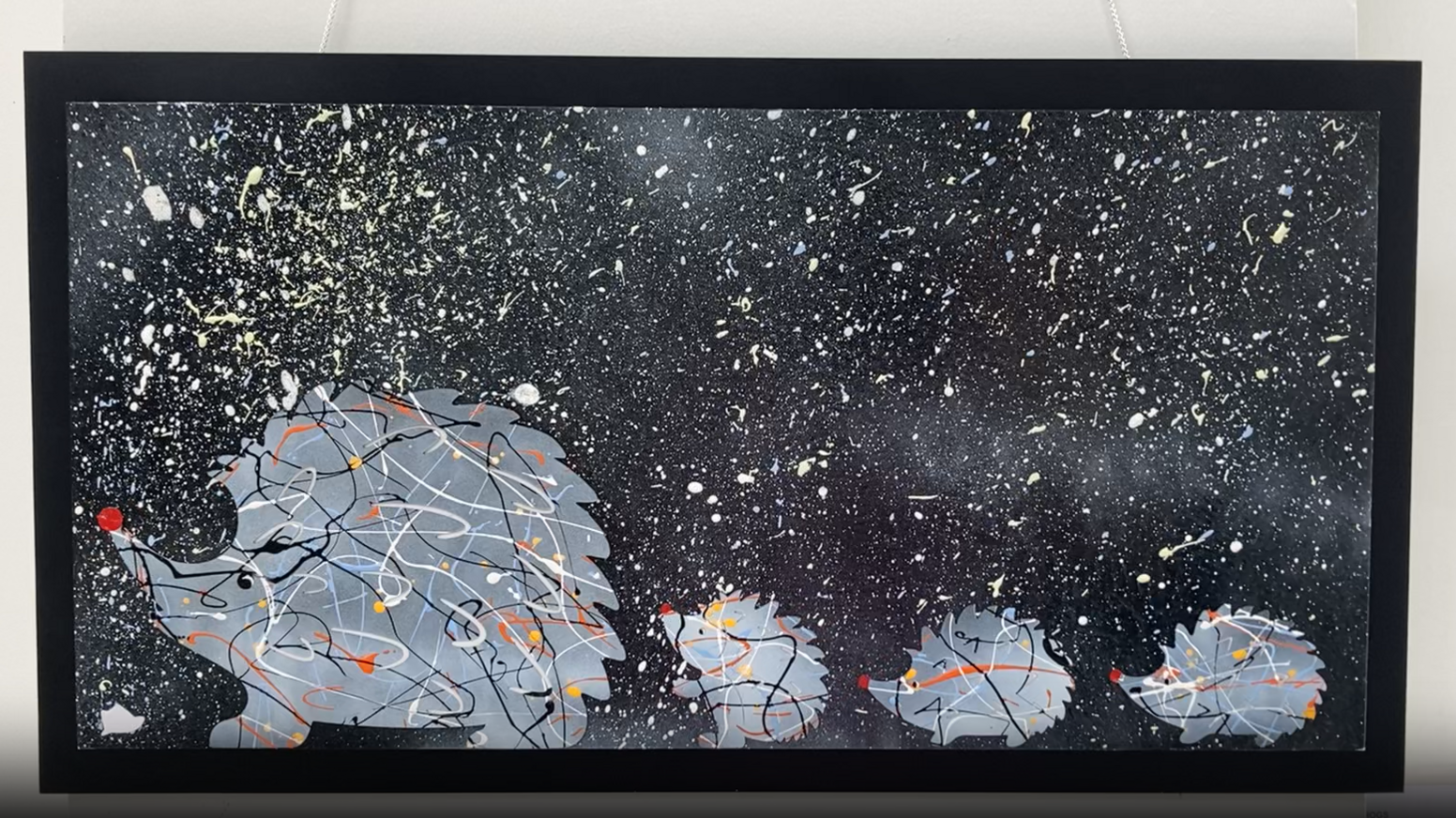 Four hedgehogs are painted in a line, one behind the other. The one at the start of the line is larger than the others. They have faces and red noses. The scene behind them is black and splattered with white paint.