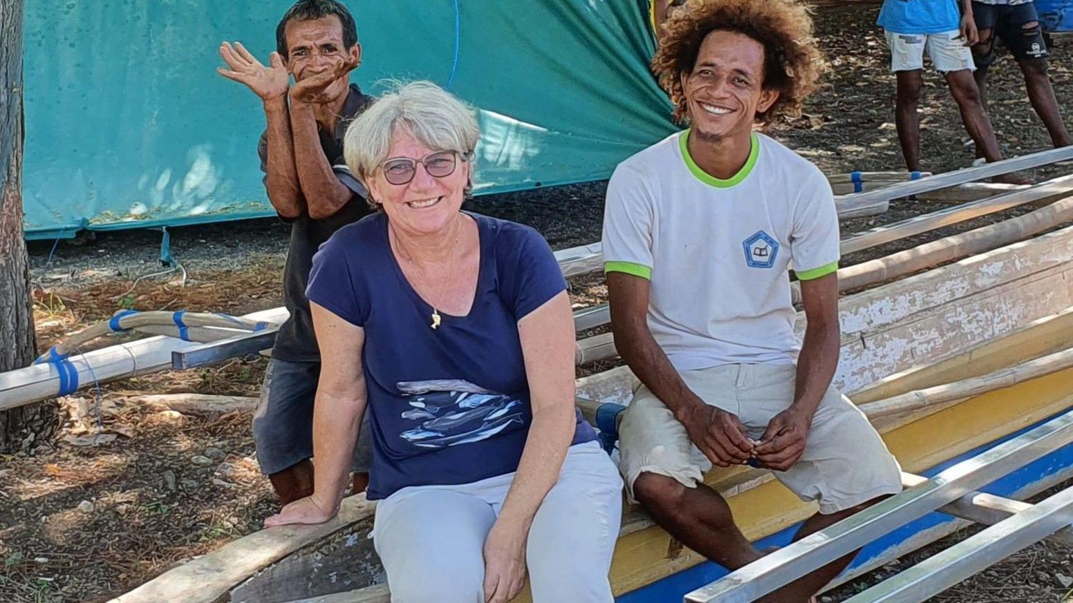 Faustino Mauloko da Cunha, Karen Edyvane, Zacarias da Cunha seated on a dugout canoe in Subaun 