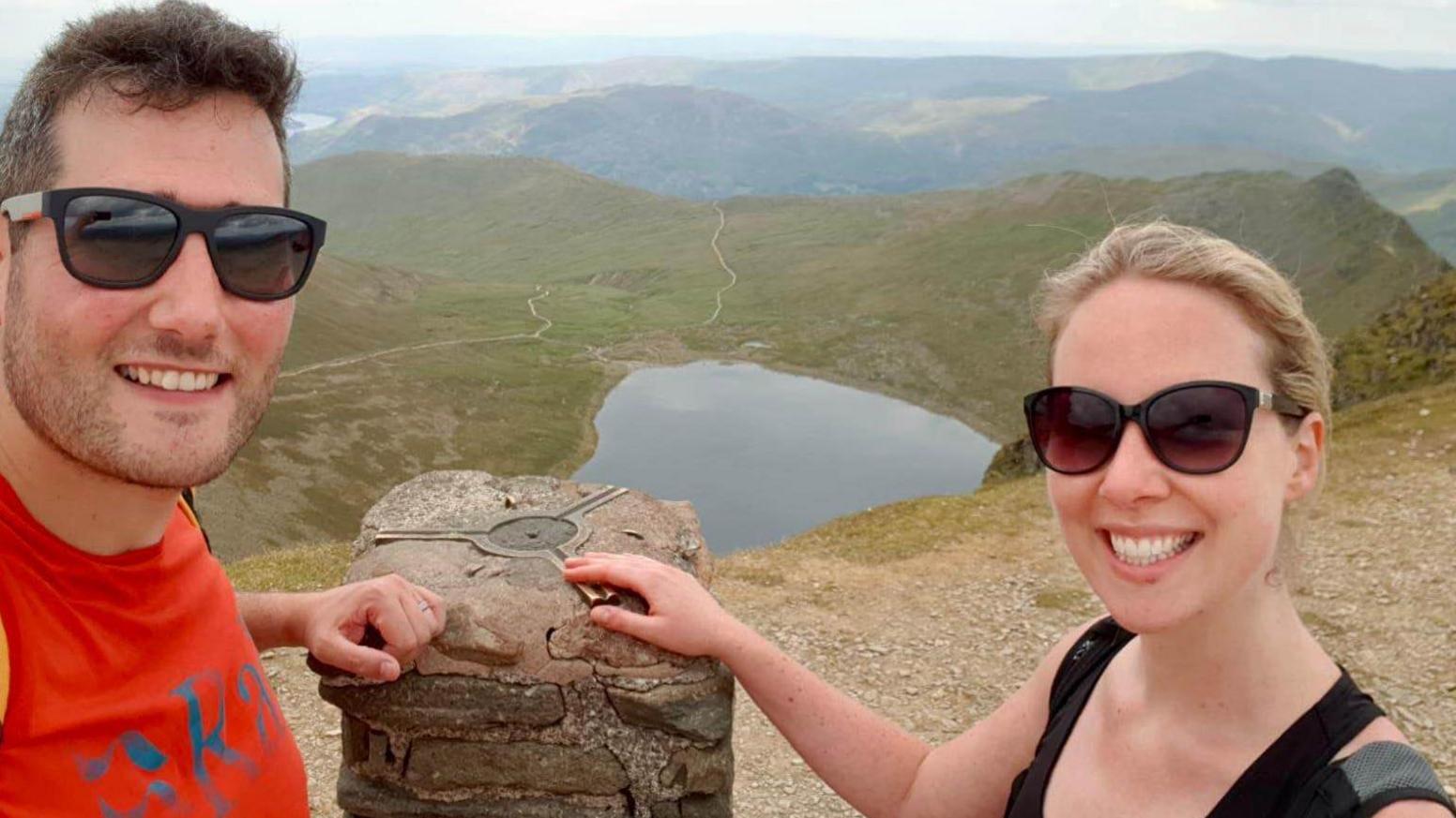 Sam and Emma Perkins pictured at the summit of a mountain