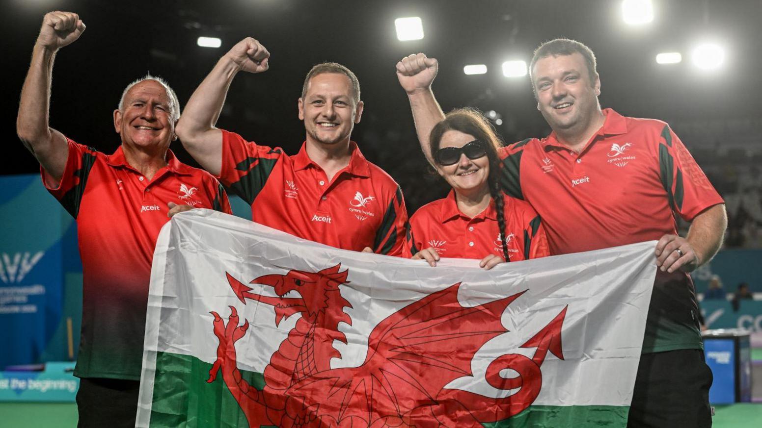 John Wilson, Steffan James, Julie Thomas and Jamie Jones celebrate bronze with a Wales flag