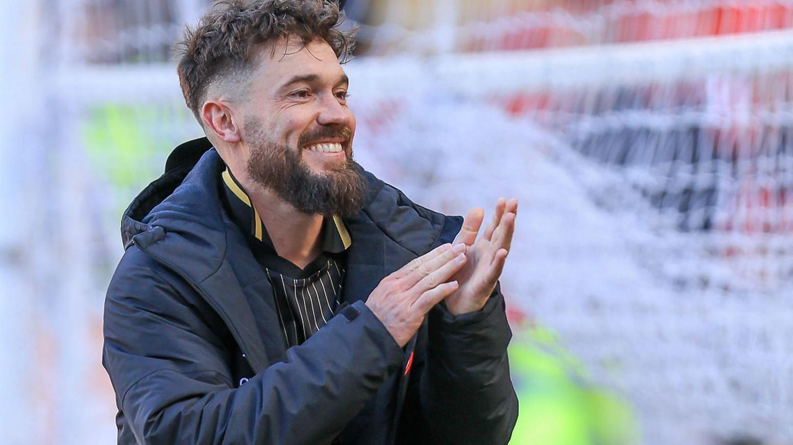 Tom Bradshaw claps the fans at the end of a Barnsley game