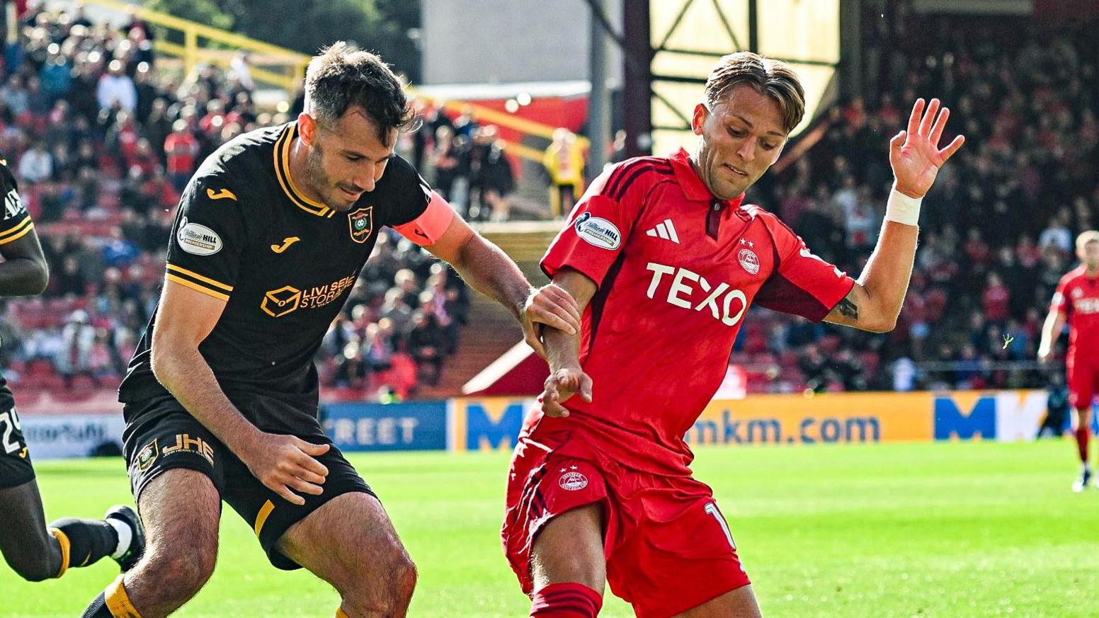 Jesper Karlsson battles for possession against Livingston