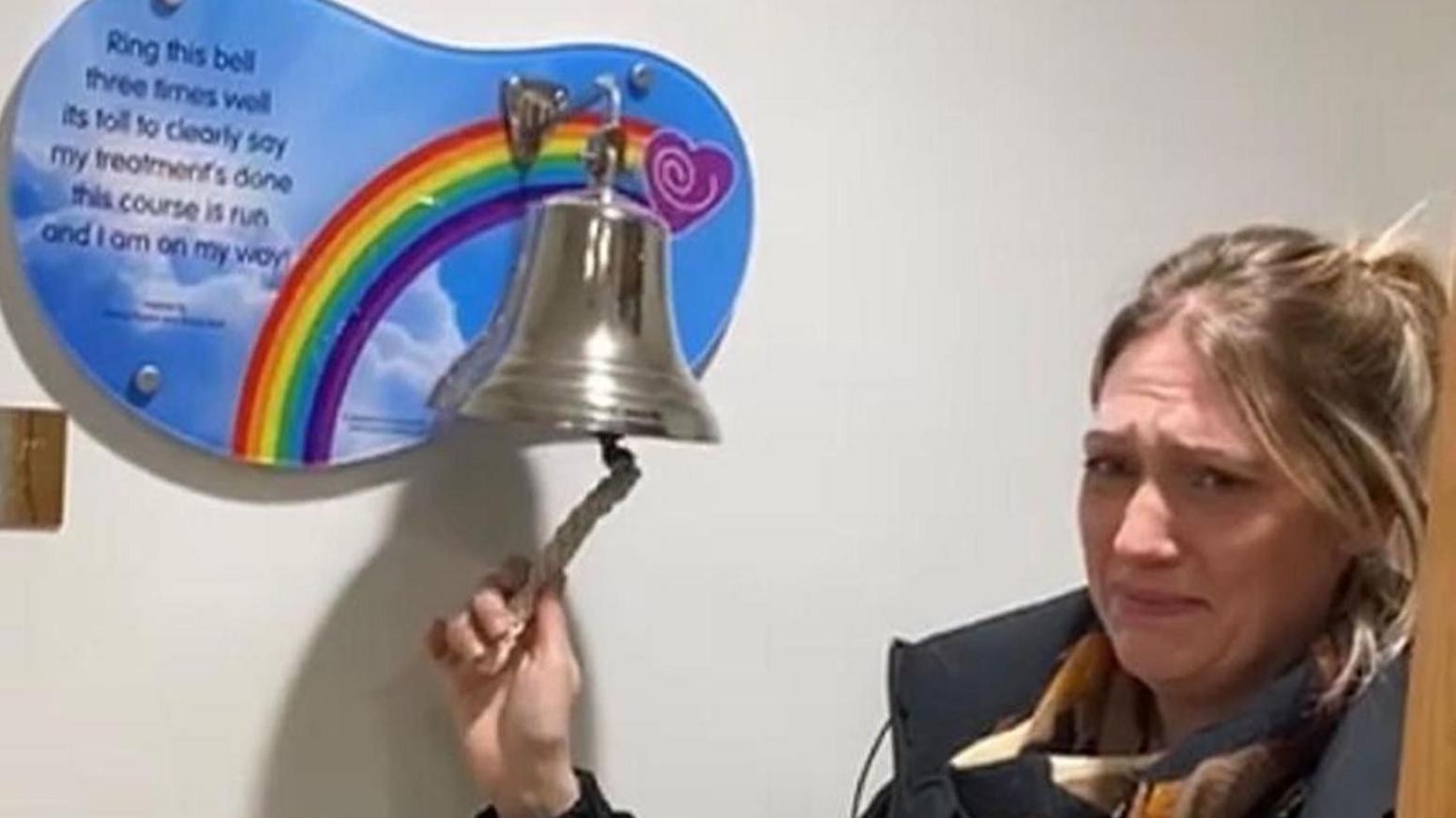 Lyndsey Ainscough rings the bell at Christie's to proclaim she is cancer freem she is can