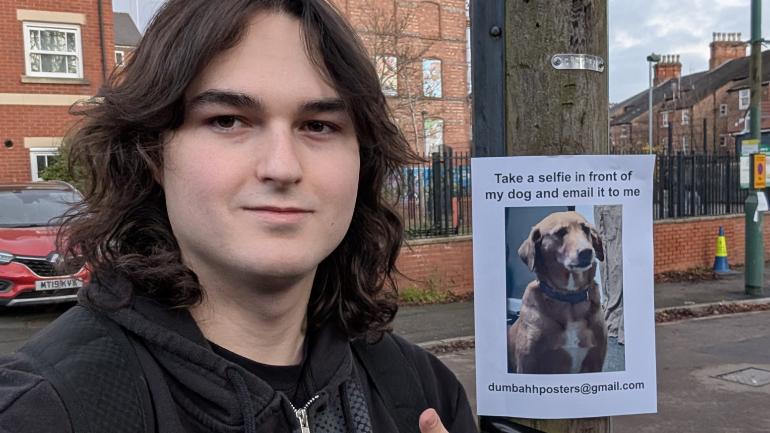 Michiel Holemans taking a selfie with one of his own posters in Nottingham.