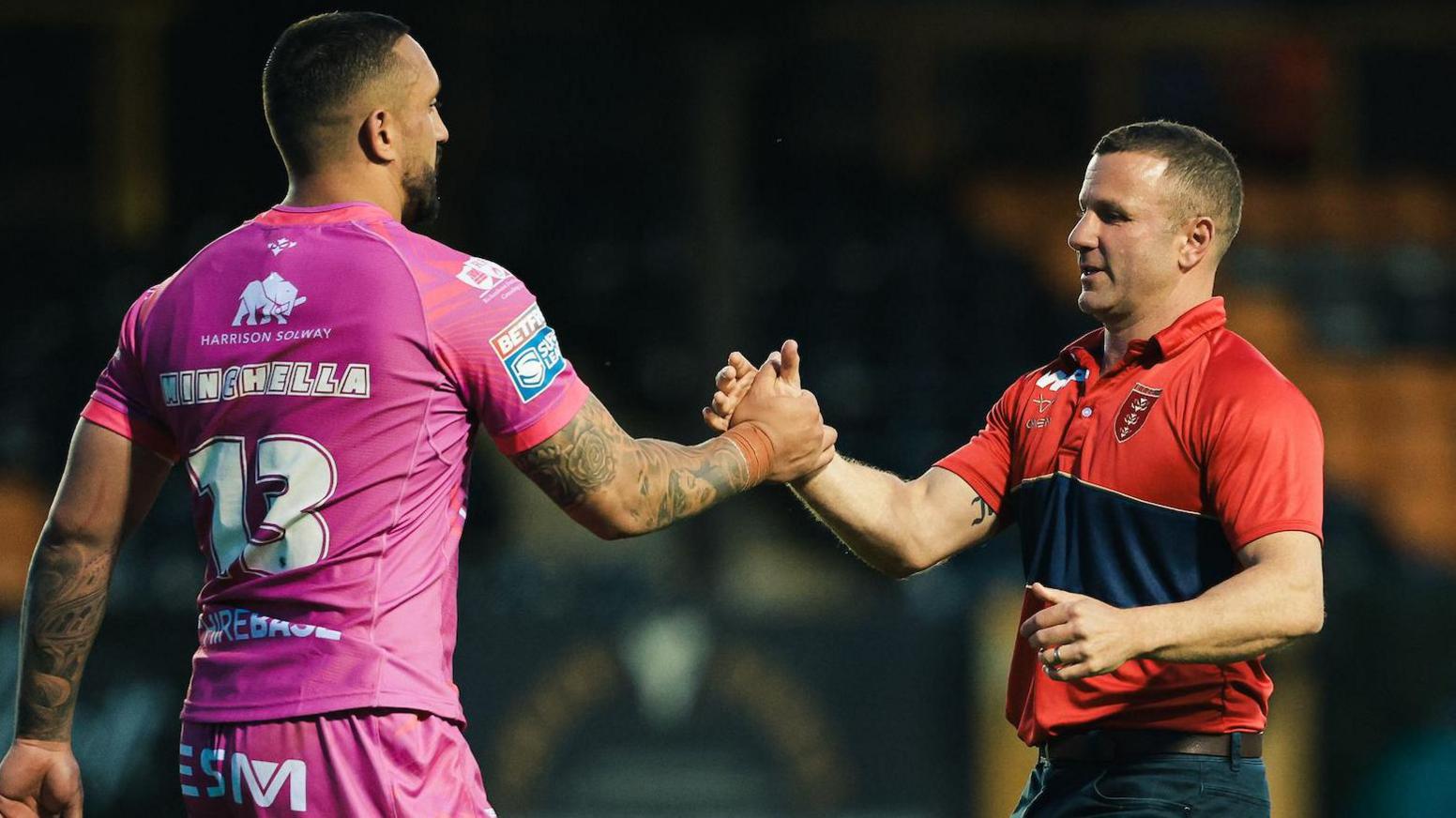 Elliot Minchella shakes the hand of coach Willie Peters after Hull KR win away at Castleford