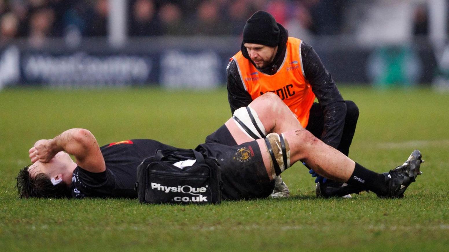 Tom Hooper lies on the ground injured