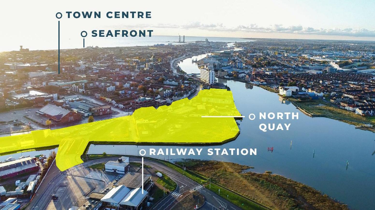 An aerial view of the proposed North Quay Waterfront site. The area set for regeneration has been shaded in yellow. The rest of the town, including the North Sea and River Yare, stretches off into the distance.