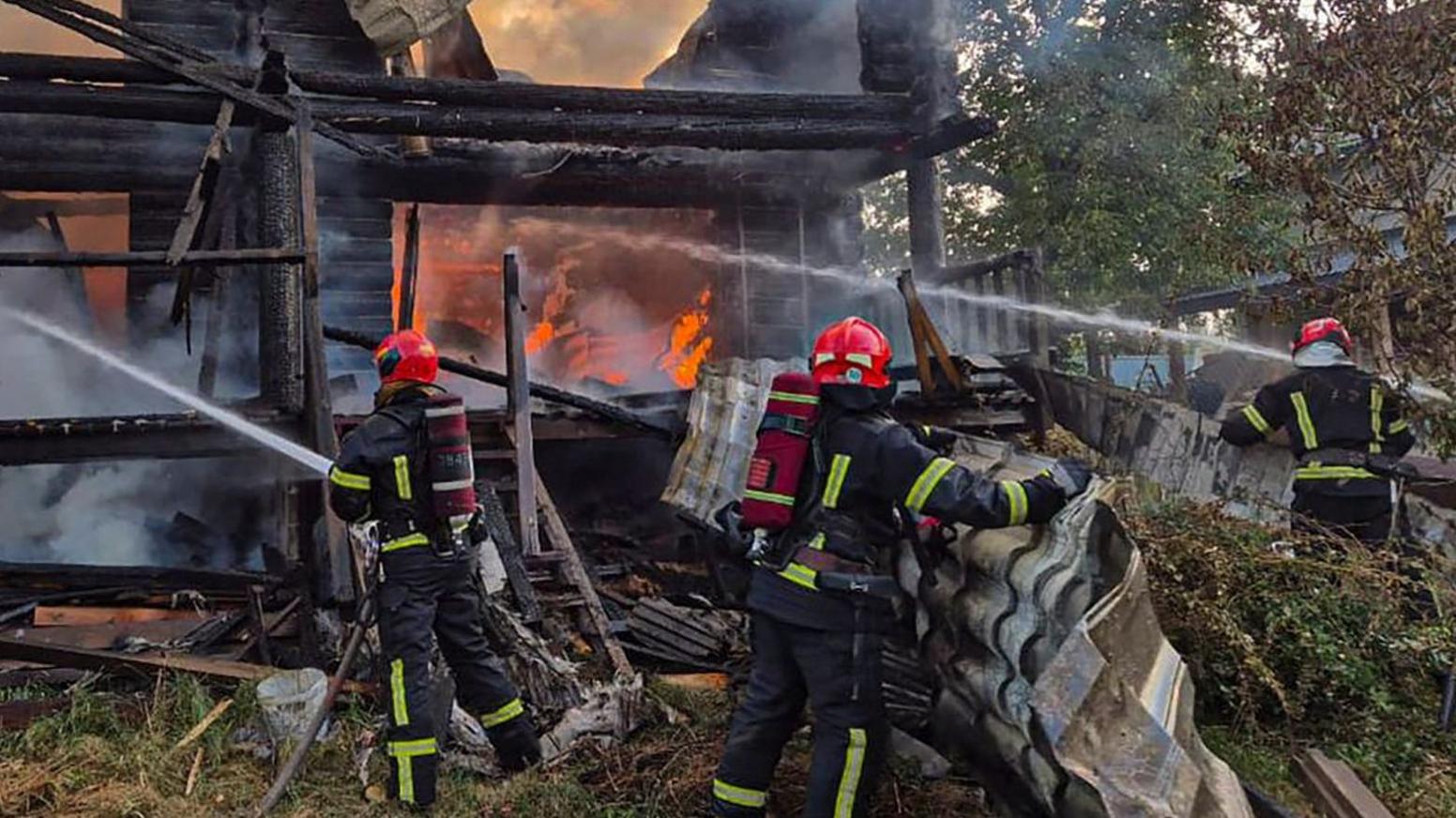Firefighters work at the site of a residential area hit during Russian drone and missile strikes in Lviv 