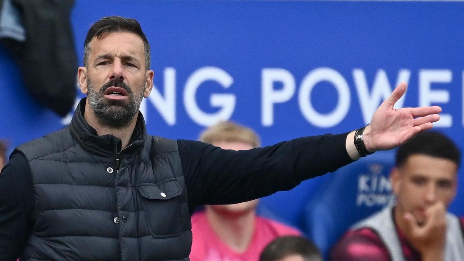Ruud van Nistelrooy extends his left arm as he gives directions to his players