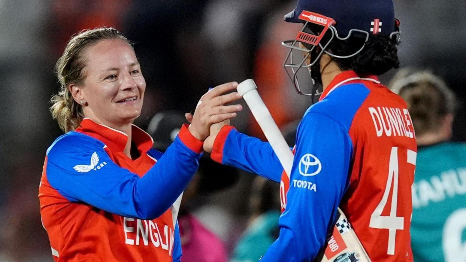 England batters Danni Wyatt-Hodge and Sophia Dunkley celebrate victory