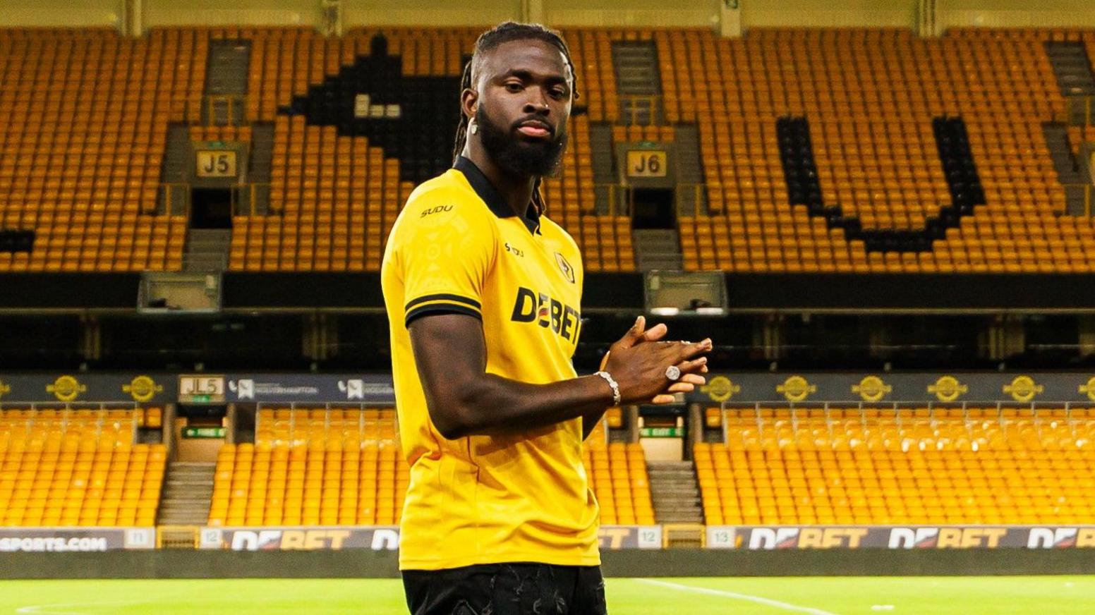 Tolu Arokodare posing on the side of the Molineux pitch