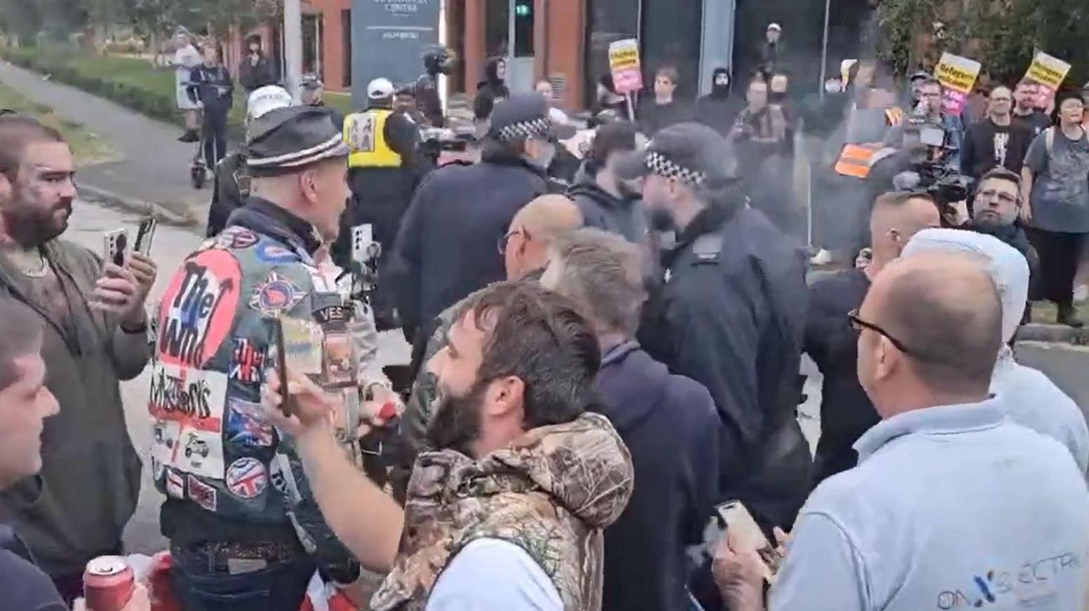 Police between anti-immigrant and anti-racist protesters in Chatham