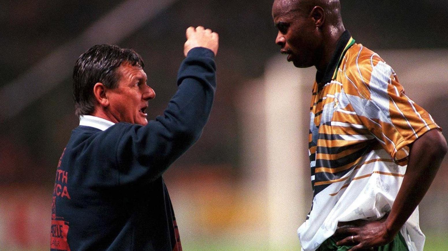 South Africa coach Clive Barker issues instructions to forward Phil Masinga during a game in 1997