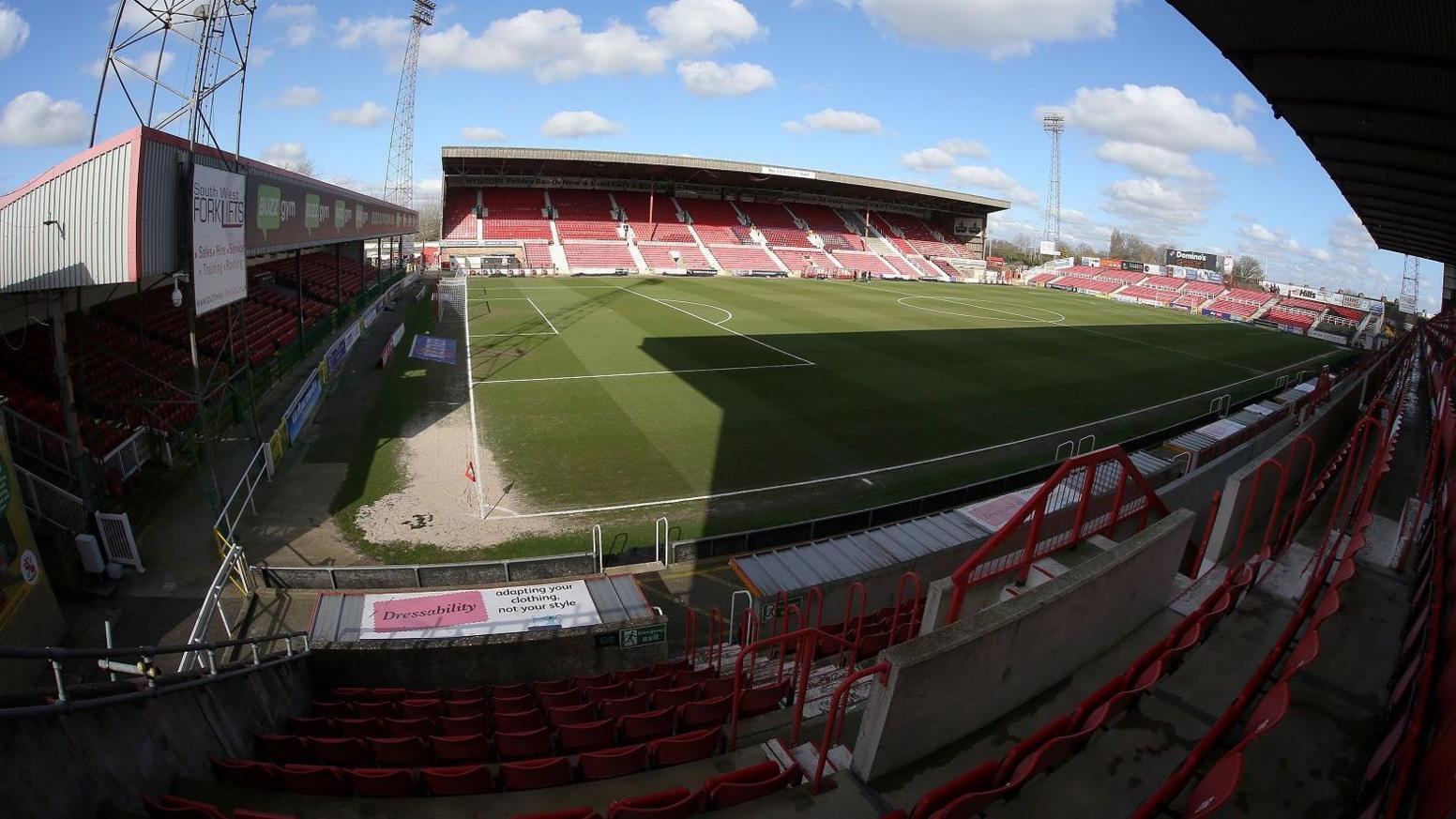 A wide shot of the County Ground in Swindon showing empty stands