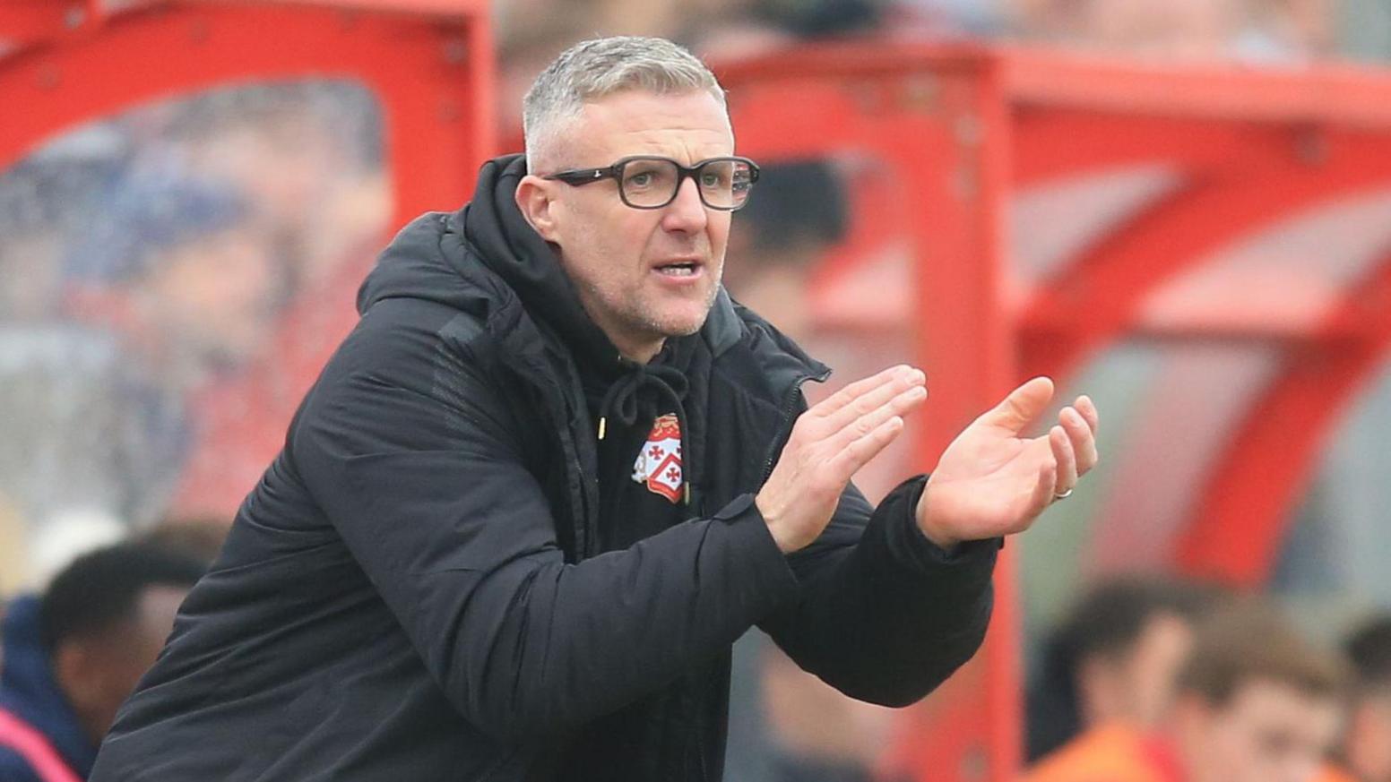 Kettering Town boss Richard Lavery encourages his team from the dugout during their FA Cup tie against Doncaster