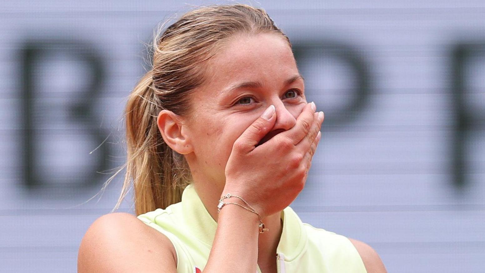 Polish qualifier Maja Chwalinska covers her mouth with her hand after completing victory over Anna Kalinskaya 