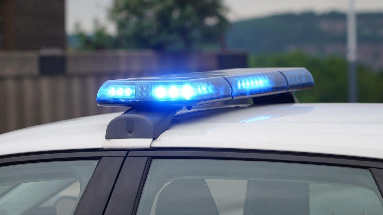 A blue light on top of a police car.