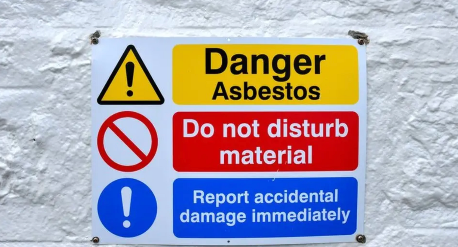 A sign reading Danger Asbestos, do not disturb material, report accidental damage immediately