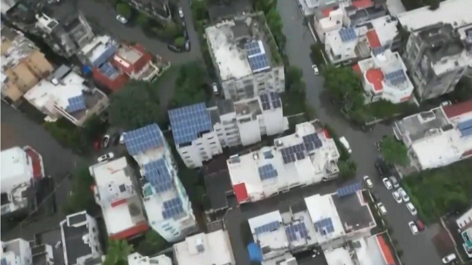 Aerial view of Vadodara city shows buildings surrounded by waterlogged roads 