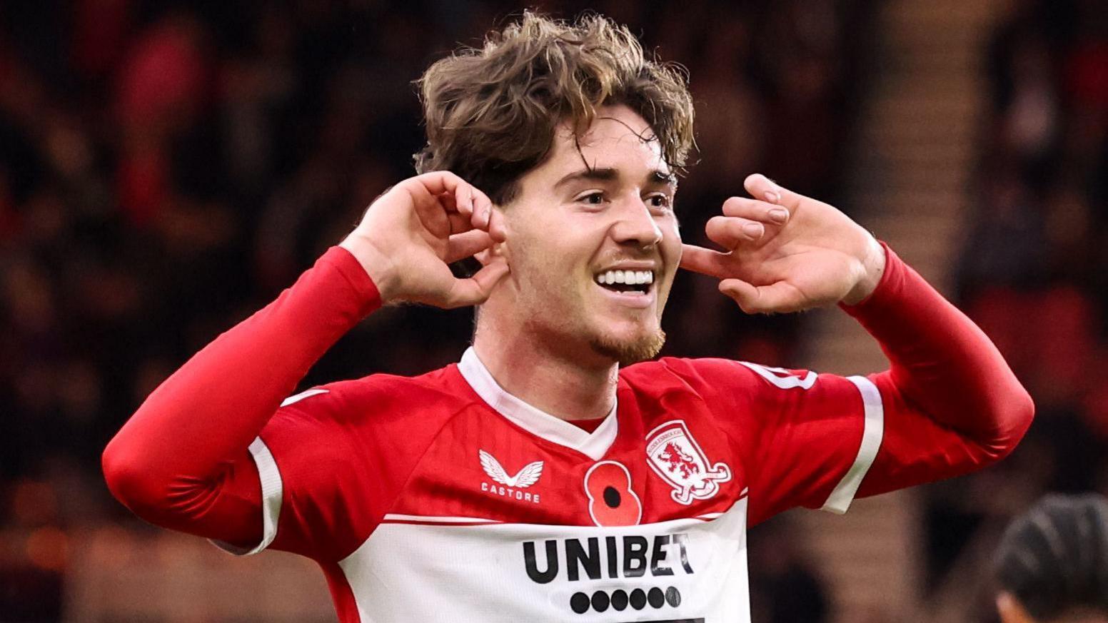 Hayden Hackney places his fingers in his ears in celebration